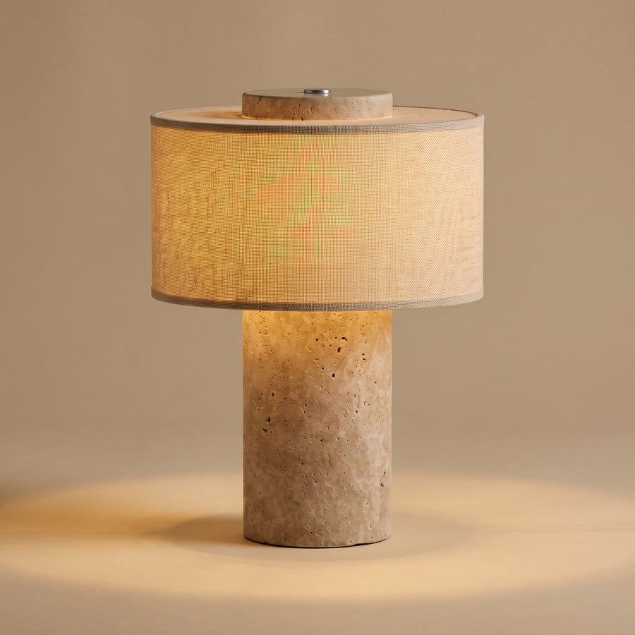 Auren rechargeable stone table lamp, lit, on warm beige studio background