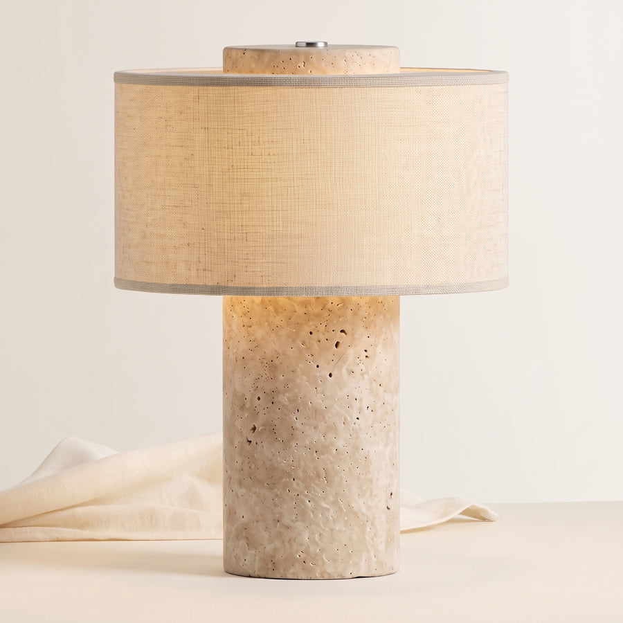 Auren rechargeable stone table lamp, lit, on a warm off-white background