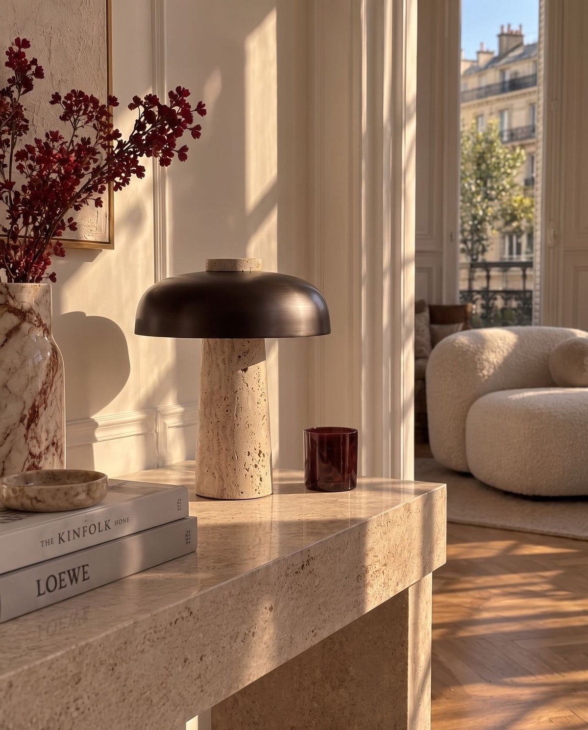 Silex rechargeable travertine table lamp on a travertine console in a sunlit Parisian apartment