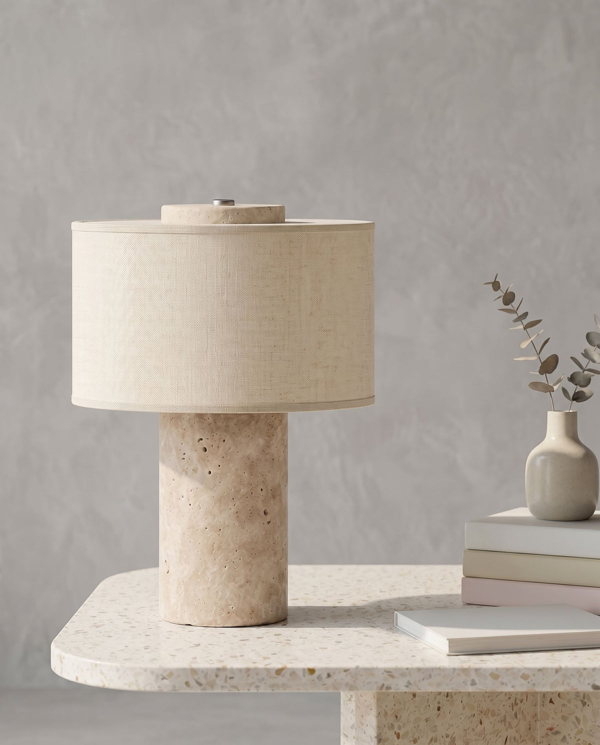 Auren rechargeable stone table lamp on a terrazzo table against a grey plaster wall