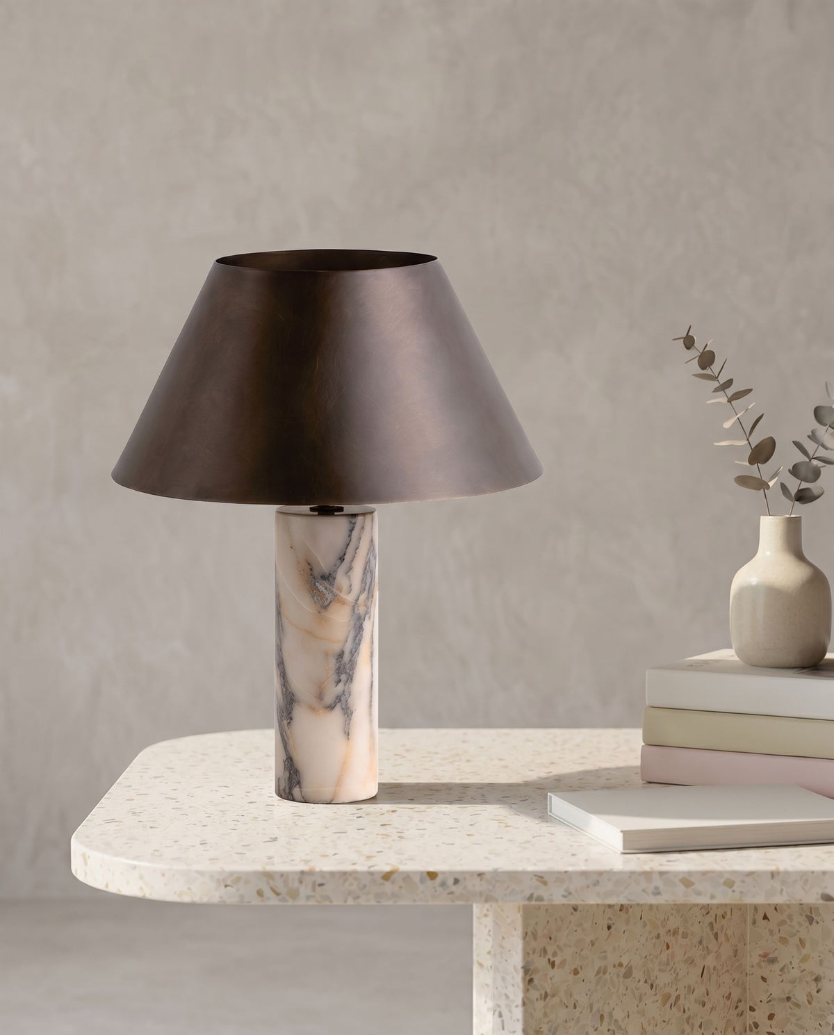 Cline Vesper marble and metal table lamp on a terrazzo table, grey wall