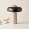 Silex rechargeable travertine table lamp on a cream backdrop with linen cloth
