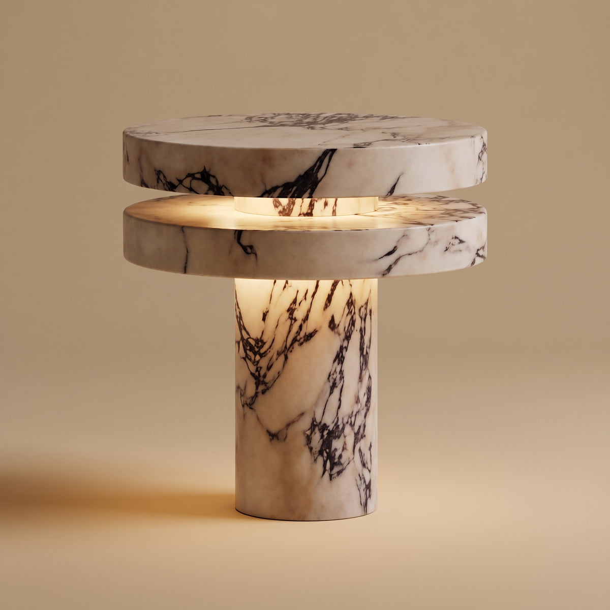 Strates marble table lamp, lit, on a warm beige studio background