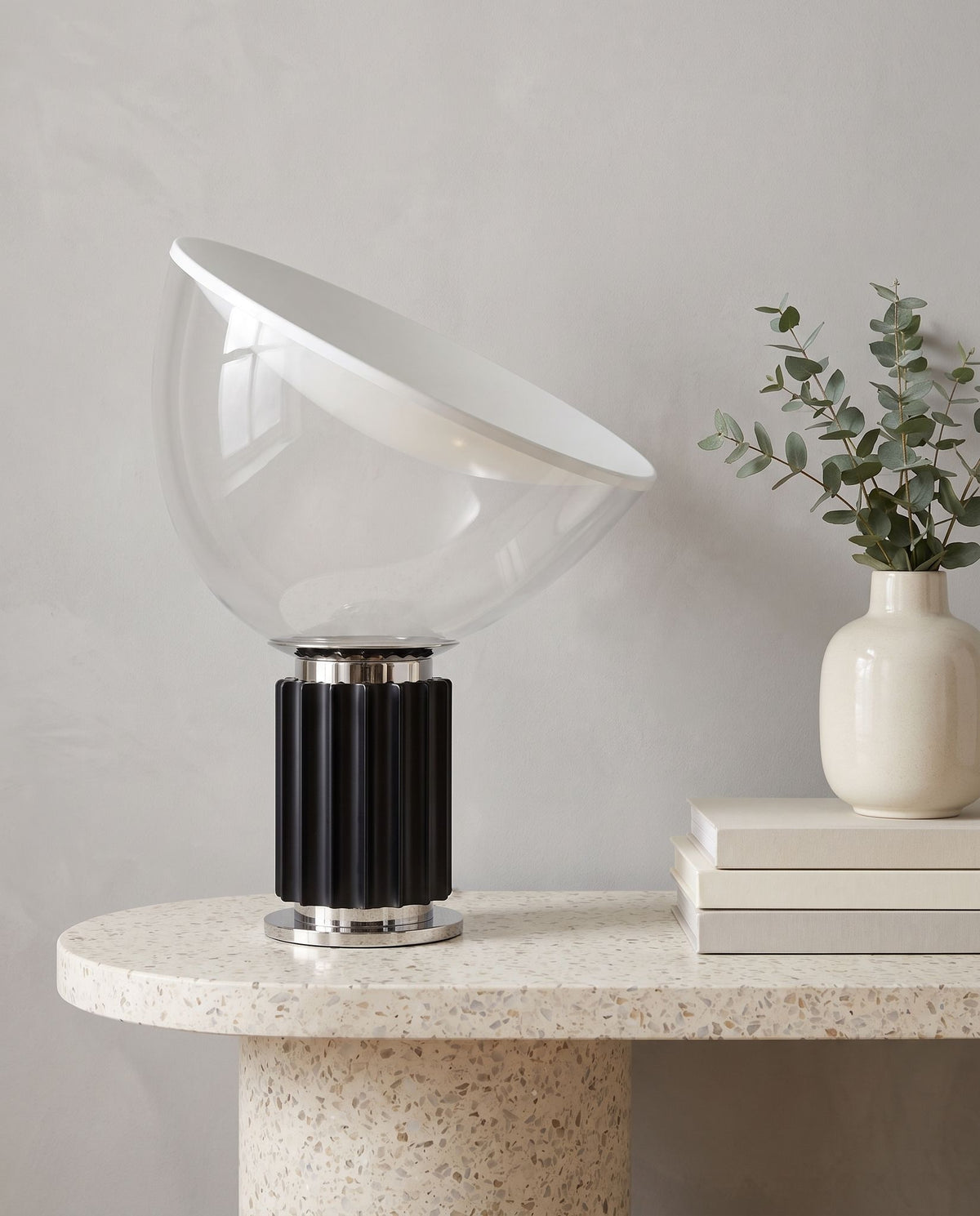 Zenith glass and metal table lamp on a terrazzo console, eucalyptus vase